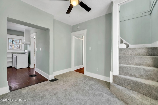 interior space with visible vents, baseboards, ceiling fan, and carpet flooring