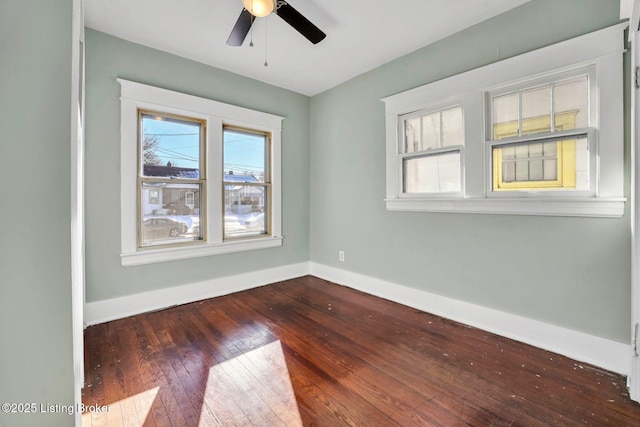 spare room featuring a ceiling fan, baseboards, and hardwood / wood-style floors