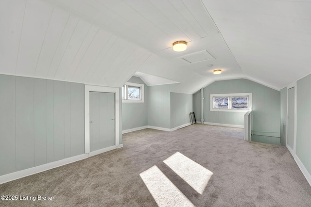 bonus room featuring lofted ceiling and carpet flooring