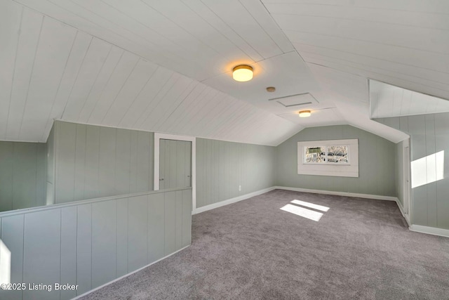 bonus room with baseboards, carpet floors, and vaulted ceiling