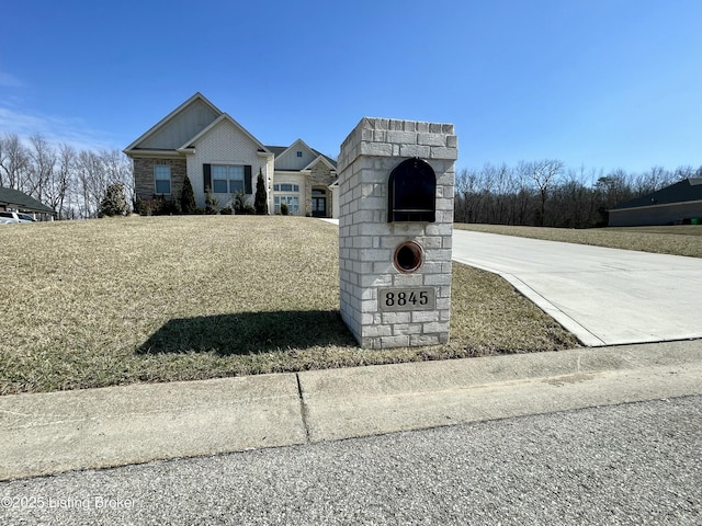 exterior space with brick siding and concrete driveway