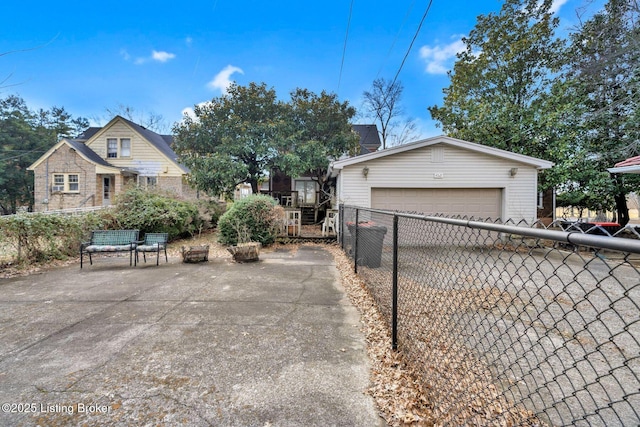 view of side of property with a garage, fence, and an outdoor structure