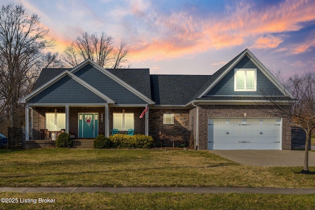 view of front of home featuring a garage, concrete driveway, a front yard, a porch, and brick siding