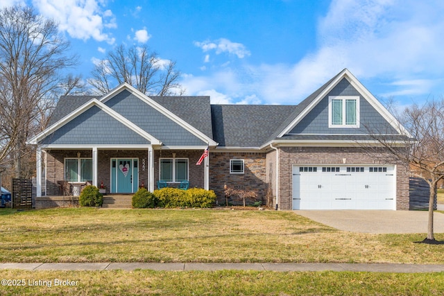 view of front facade with a garage, concrete driveway, a front yard, a porch, and brick siding