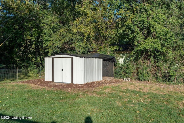 view of shed featuring fence