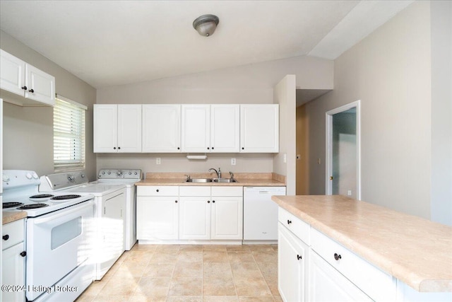 kitchen with lofted ceiling, white appliances, a sink, and white cabinetry