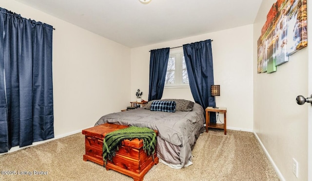 carpeted bedroom featuring baseboards