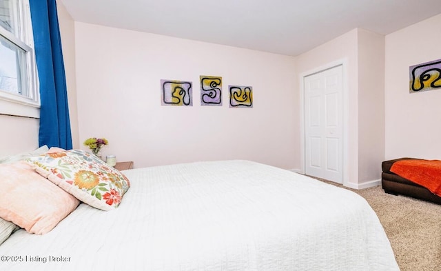 carpeted bedroom with baseboards