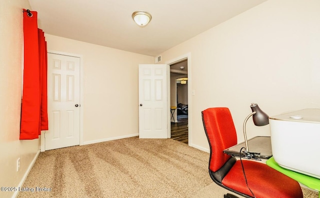 carpeted home office featuring visible vents and baseboards