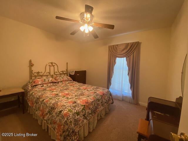 bedroom featuring a ceiling fan and light colored carpet