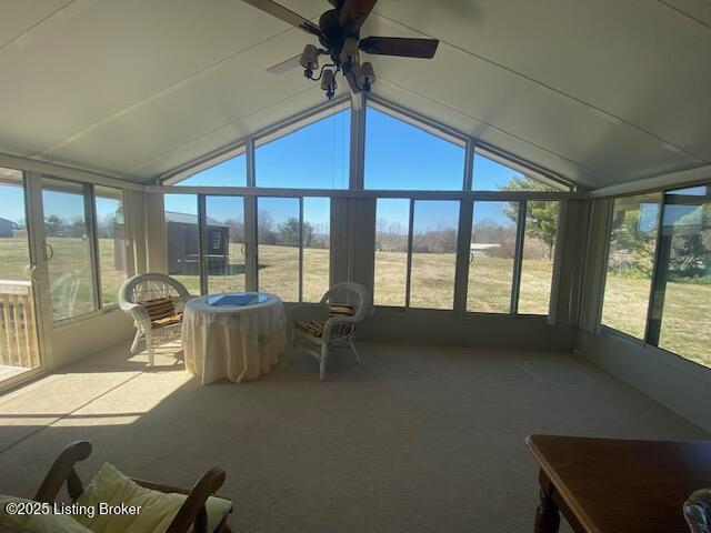 sunroom / solarium with a ceiling fan, lofted ceiling, and a wealth of natural light