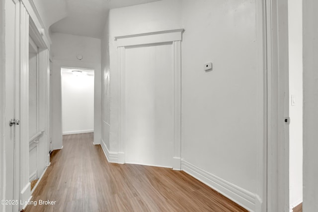 corridor with light wood-type flooring