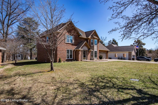 view of front of property featuring a front yard, brick siding, driveway, and an attached garage