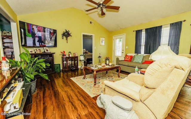 living room with a ceiling fan, lofted ceiling, plenty of natural light, and wood finished floors