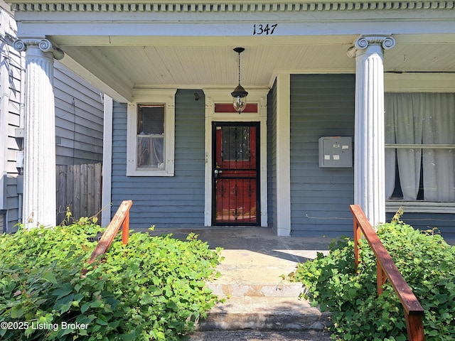 view of exterior entry featuring covered porch