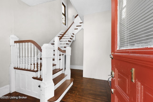 stairway featuring wood finished floors and baseboards