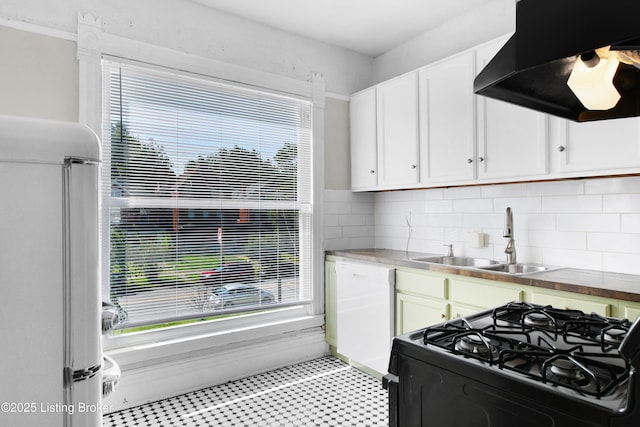 kitchen with white appliances, plenty of natural light, extractor fan, and a sink