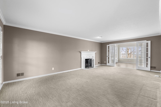 unfurnished living room with visible vents, a fireplace, ornamental molding, french doors, and light carpet