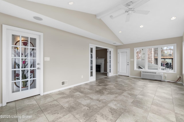 unfurnished living room with visible vents, vaulted ceiling with beams, a wall unit AC, a fireplace, and a ceiling fan