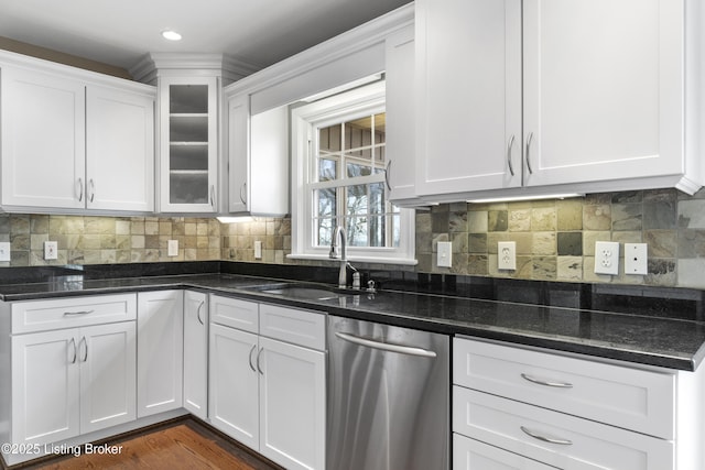 kitchen with backsplash, dishwasher, white cabinetry, and a sink