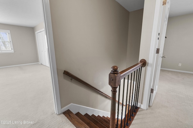 stairway featuring carpet flooring and baseboards