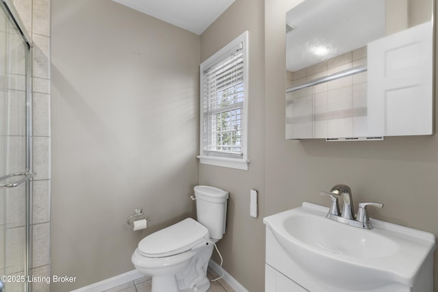 full bathroom featuring tile patterned flooring, baseboards, toilet, tiled shower, and vanity