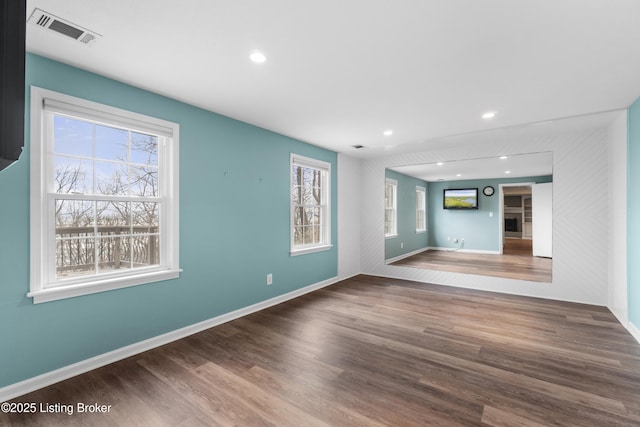 unfurnished room with recessed lighting, visible vents, and wood finished floors