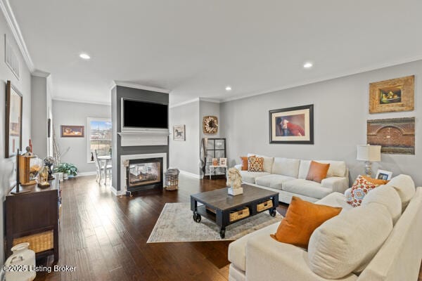 living room featuring recessed lighting, dark wood-type flooring, a multi sided fireplace, baseboards, and ornamental molding