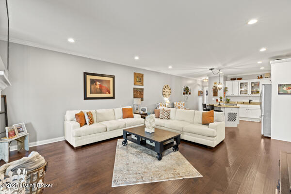 living room with recessed lighting, dark wood finished floors, and baseboards