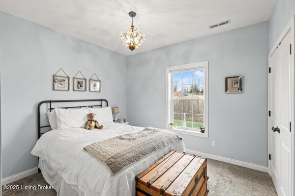 bedroom with an inviting chandelier, carpet, visible vents, and baseboards