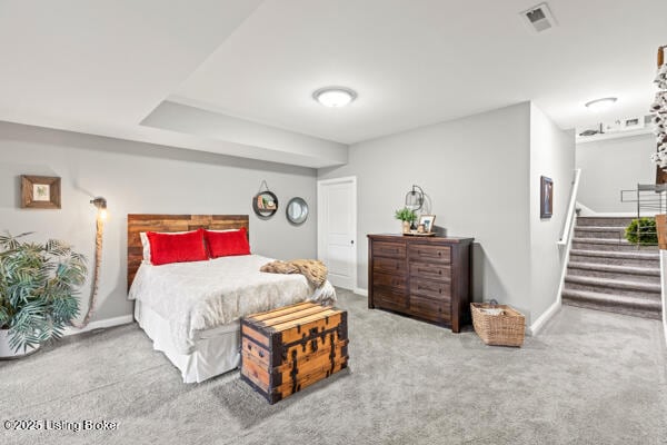 carpeted bedroom featuring visible vents and baseboards