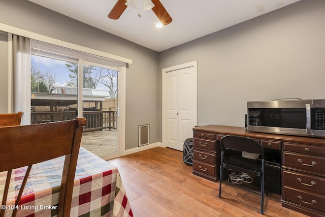 office with baseboards, ceiling fan, and light wood finished floors