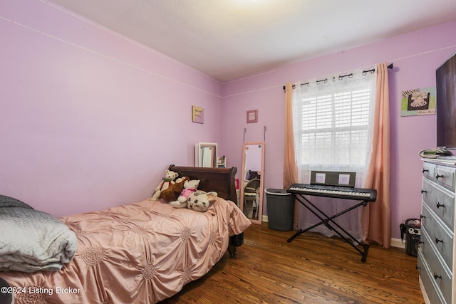 bedroom featuring wood finished floors