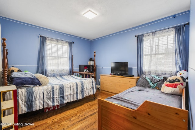 bedroom with wood finished floors