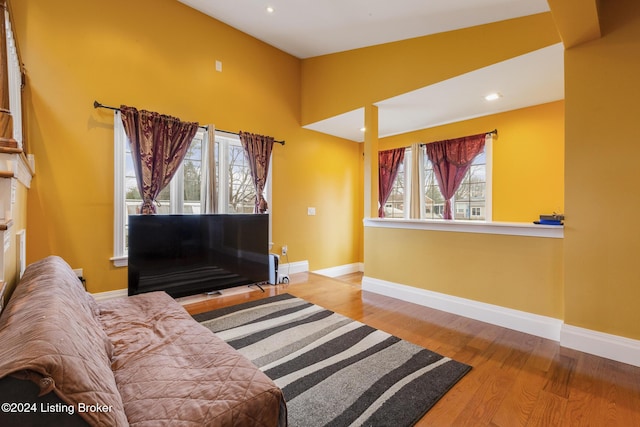 sitting room featuring lofted ceiling, baseboards, wood finished floors, and recessed lighting