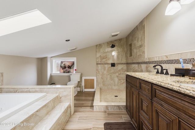 bathroom with lofted ceiling with skylight, a garden tub, toilet, and a walk in shower