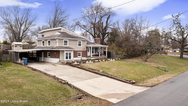 view of front facade featuring driveway, a chimney, a front lawn, a carport, and brick siding