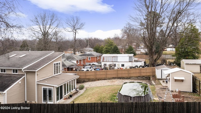 exterior space featuring a fenced backyard, a storage unit, and an outdoor structure