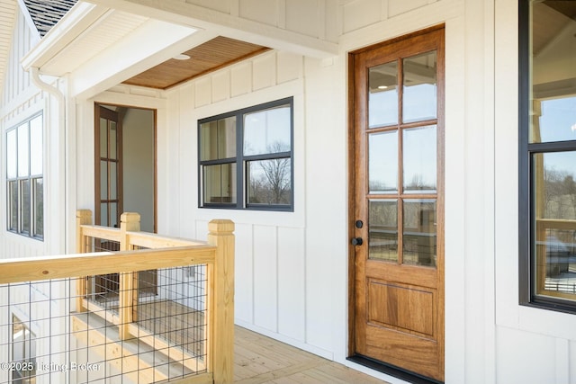 view of exterior entry featuring board and batten siding