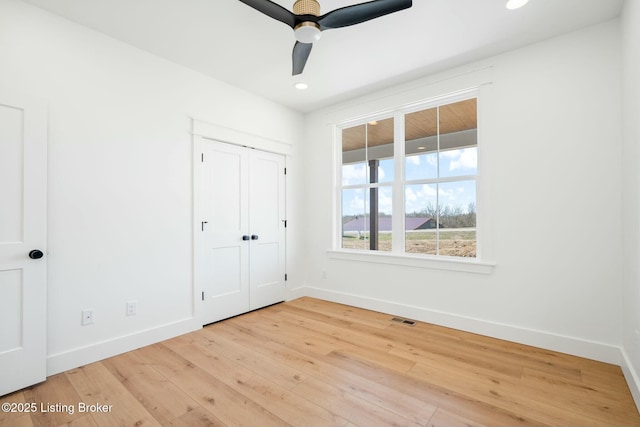 unfurnished bedroom featuring visible vents, baseboards, and hardwood / wood-style flooring