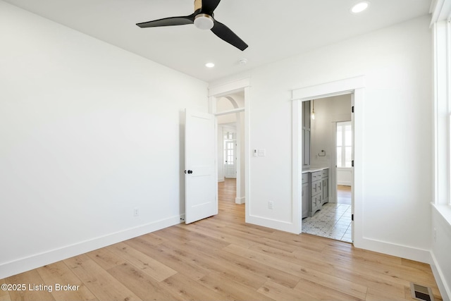 unfurnished bedroom with visible vents, baseboards, recessed lighting, light wood-style floors, and connected bathroom