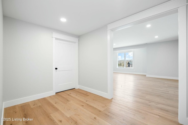 spare room with recessed lighting, baseboards, and light wood-style floors