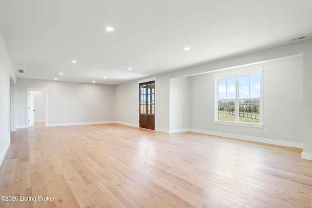 spare room featuring visible vents, recessed lighting, light wood-type flooring, and baseboards