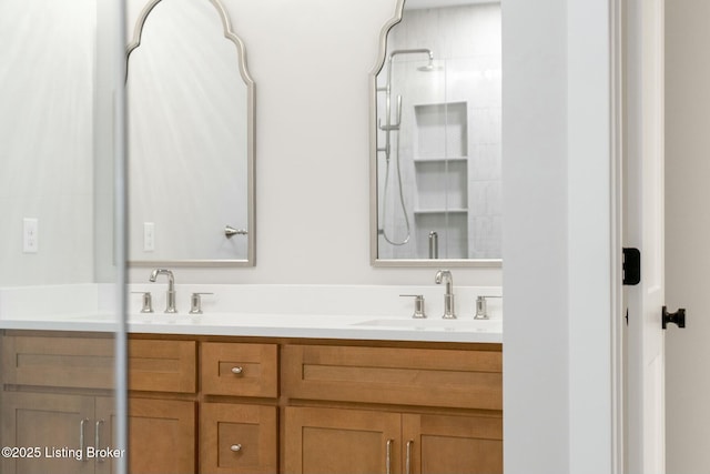 full bath featuring double vanity, walk in shower, and a sink