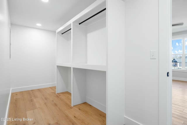 spacious closet featuring light wood-style flooring