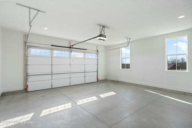 garage featuring recessed lighting, baseboards, and a garage door opener