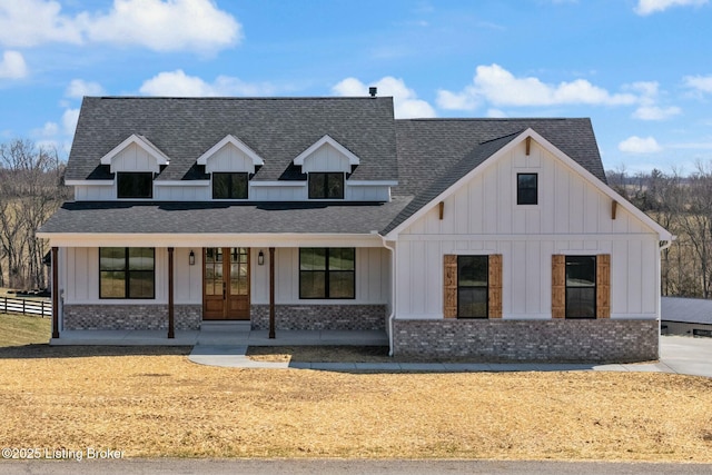 modern inspired farmhouse featuring french doors, fence, board and batten siding, and a shingled roof