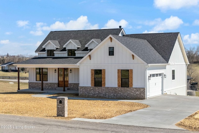 modern farmhouse featuring french doors, roof with shingles, board and batten siding, and an attached garage