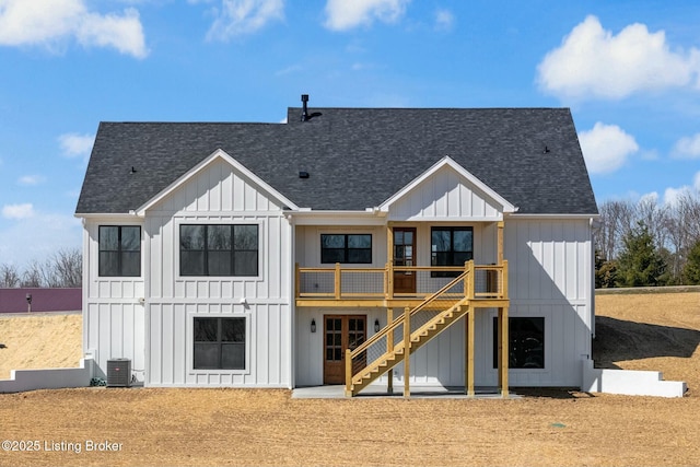 back of house with stairway, board and batten siding, and a shingled roof