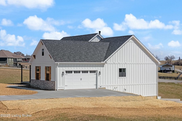 exterior space featuring driveway, an attached garage, board and batten siding, and roof with shingles